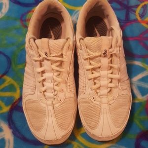 White and pink pair of Nike athletic  shoes